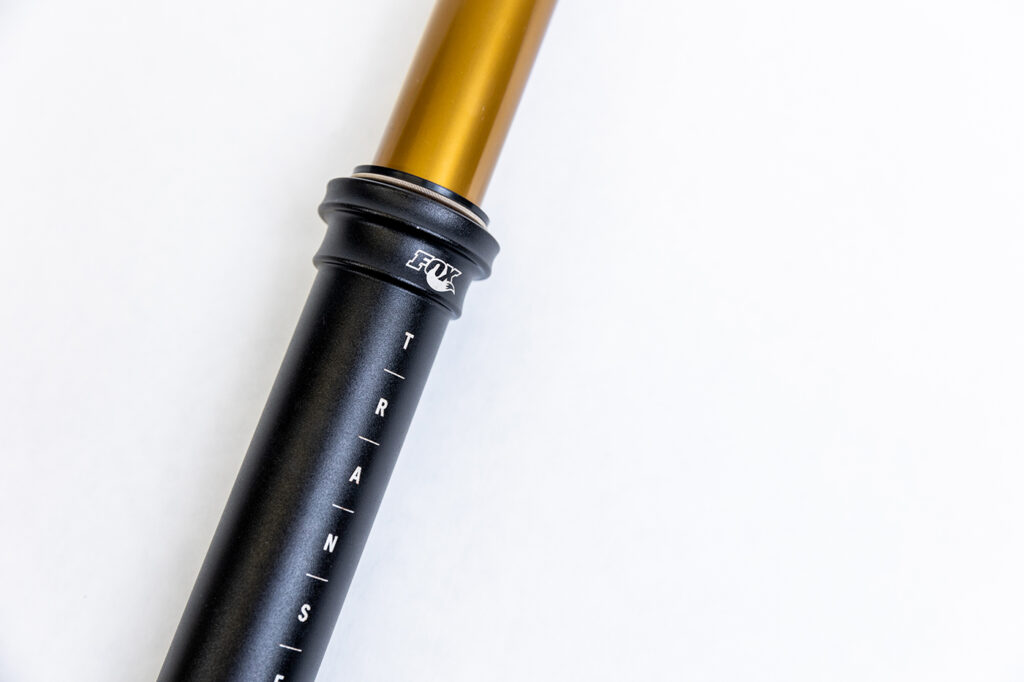 close up of a black and kashima coated fox transfer dropper post
